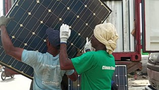 two men in Nigeria handling solahart solar panels